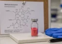 Methylcobalamin crystalline powder vial with molecular structure diagram