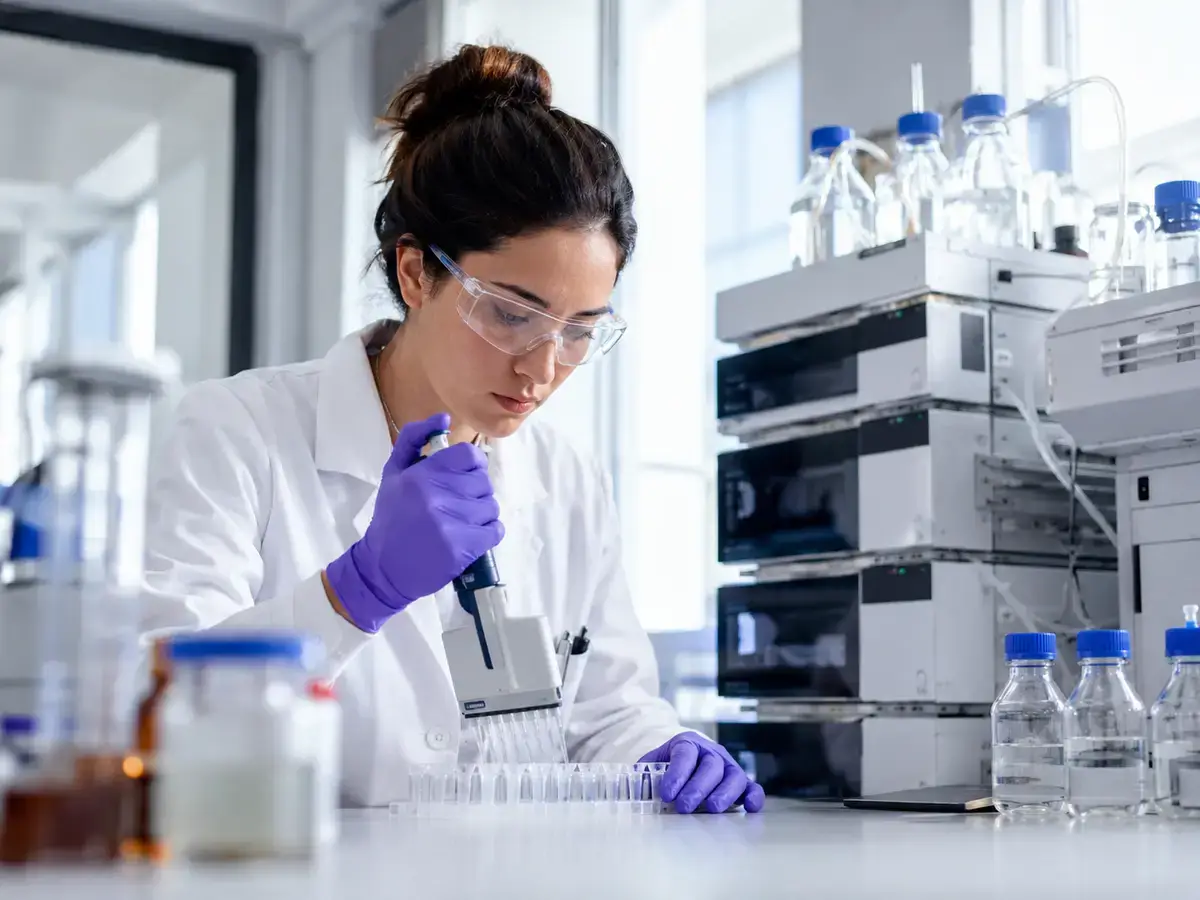 Scientist preparing recombinant IGF-1 analog samples in a research lab