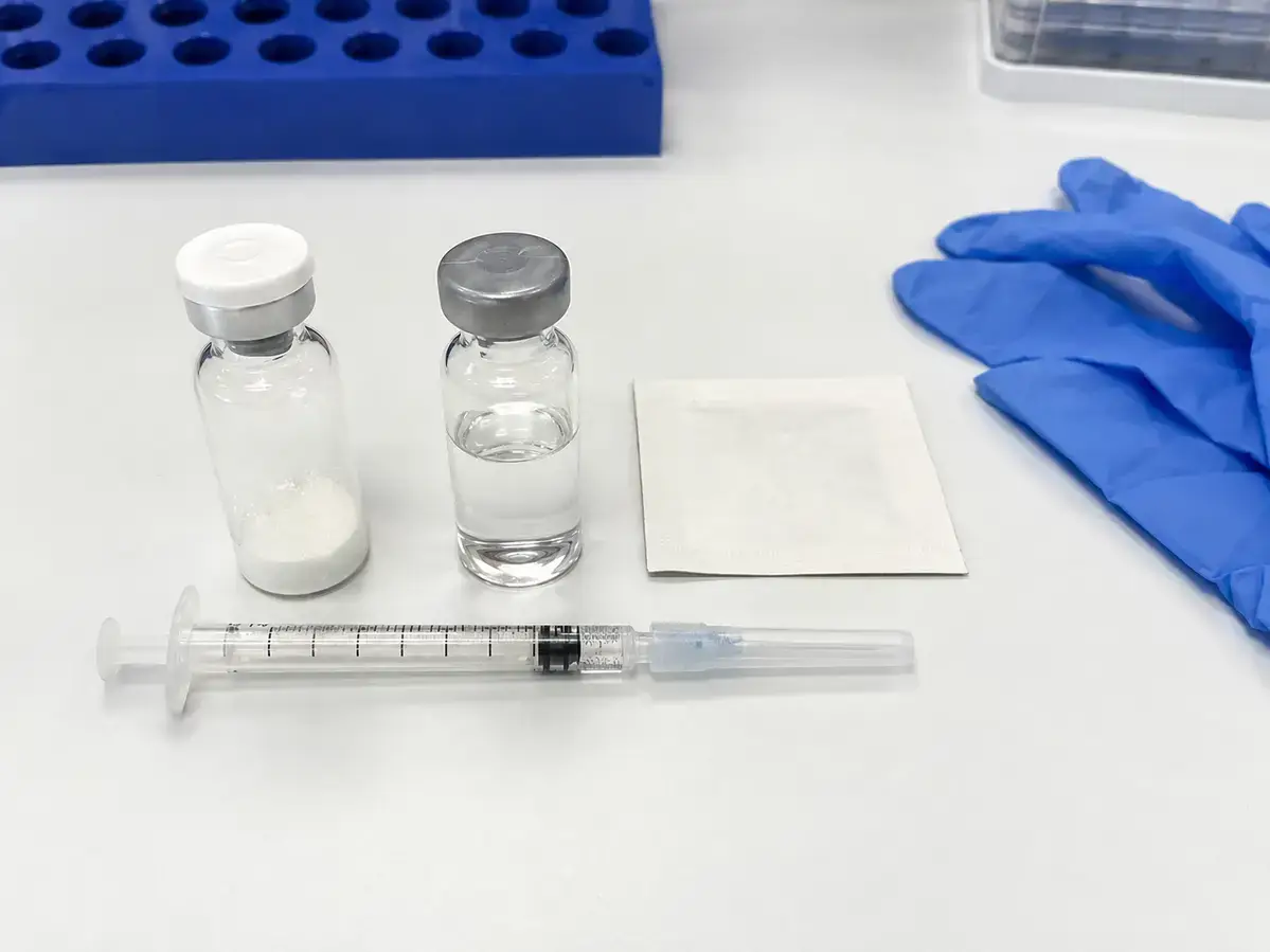 Peptide reconstitution supplies on laboratory bench for KLOW blend research